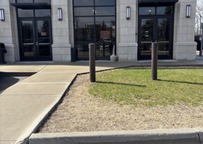 Entrance of government building with glass doors and concrete walkway